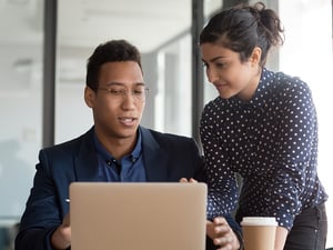 Young-multiracial-black-and-indian-colleagues-working-together-at-office